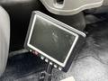 A black monitor on a stand displaying a dark screen with buttons along the bottom
