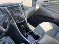 Interior view of a 2014 Hyundai Sonata showcasing the center console with audio controls gear shifter and seating in gray fabric