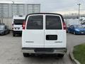 A white 2004 Chevrolet Express van viewed from the rear with a blank license plate and red taillights