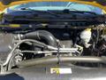 Engine compartment of a 2015 RAM 1500 showcasing the air intake hose battery and fluid reservoirs