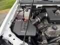 An open hood of a 2012 GMC Canyon revealing the engine components including the air intake and coolant reservoir