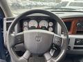 Steering wheel and dashboard of a 2006 Dodge Ram 2500 featuring multiple gauges and controls