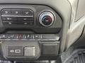 Dashboard controls of a 2024 Chevrolet Silverado 1500 featuring climate control buttons and a temperature dial