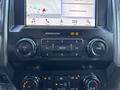 Dashboard of a 2019 Ford F-550 featuring a touchscreen display with navigation and audio controls alongside various buttons for volume and media settings