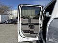 A 2018 Ford F-150 door is open showing the interior door panel with controls and armrest in gray and black colors
