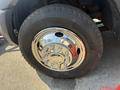 Close-up of a shiny chrome wheel hub and tire on a 2011 Dodge Ram 5500 showcasing detailed lug nuts and a textured tire tread