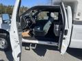A white 2016 Ford F-250 SD with the driver-side door open revealing the interior and driver's seat