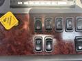 A panel with multiple switches including a yellow parking brake lever and buttons labeled Work Lamp OPT ENG FAN and RGEN