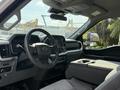 Interior view of a 2021 Ford F-150 showing the dashboard steering wheel and center console with storage compartments