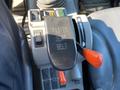 A close-up of the control panel of a 2015 Bobcat 5600 showing the seat belt fasten lever with accompanying buttons and switches