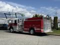 A 1994 Volvo FE 42 fire truck in red and silver with a rear-mounted water tank and hose storage compartments