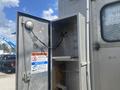 A metal service compartment door of a 2007 Morgan Olson Workhorse W42 is open revealing empty shelves and a warning sign about underground utilities