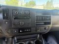 Dashboard of a 2017 Chevrolet Express with radio controls air conditioning vents and various buttons for vehicle functions