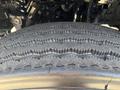 Close-up of a treaded tire from a 2014 Freightliner M2 106 showing deep grooves and patterns indicating good traction