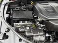 The engine compartment of a 2019 Jeep Grand Cherokee showcasing the engine block and various components like the battery and wiring harnesses