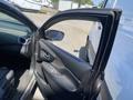 A 2017 Nissan Murano with the driver's side door open showing the interior features and controls