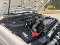 A 2009 Ford F-450 Super Duty engine compartment showing the engine components and battery with wires and hoses visible