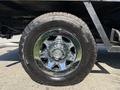 A close-up view of a chrome wheel with a black tire mounted on a 2017 Chevrolet Silverado 1500