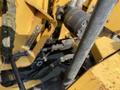 Close-up view of a 2010 Vermeer Corporation BC1200XL wood chipper showing control levers and hoses attached to the machinery