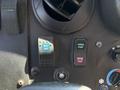Close-up of the control panel in a 2019 Freightliner MT45 featuring switches for spotlight engine start and engine stop