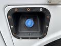 Close-up of the fuel fill neck on a 2018 Ford F-550 showing a blue cap with labels for diesel fuel and a surrounding black plastic housing