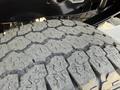 Close-up of a rugged tire tread from a 2021 Ford F-250 SD showcasing deep grooves designed for off-road traction and durability