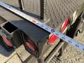 A close-up view of the flatbed of a 2011 International 7500 truck featuring measurement markings and red reflectors