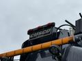 A 2018 Kenworth T800 truck with a Cusco Wastegroup logo on the rear and orange light bar visible