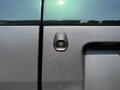 Close-up of the rear door handle and rearview camera of a 2016 Ford Transit 150