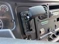 The interior control panel of a 2011 Freightliner B2 featuring a gear shifter with positions labeled R N D 2 L and various gauges and switches