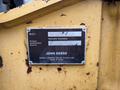 A metal nameplate displaying model information for a 2017 John Deere 50G hydraulic excavator including the product identification number and manufacturer's details