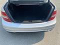 Open trunk of a 2013 Mercedes-Benz C-Class showing a black interior with no items inside
