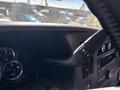 Close-up of the steering wheel and dashboard of a 2019 GMC Savana showing gauges and control buttons