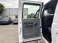 Open door of a 2014 Ford F-550 revealing a gray interior panel and seating space inside the vehicle