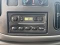 Dashboard controls of a 2008 Ford Econoline featuring a radio with knobs for volume tuning and preset buttons