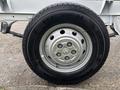 Close-up of a wheel from a 2023 RAM Promaster 3500 featuring a silver rim with multiple holes and a Nexen tire designed for durability and performance