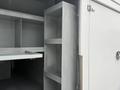 Interior view of a 2014 International TerraStar showing empty shelves and storage compartments with a metallic finish