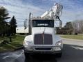 A white 2008 Kenworth T370 bucket truck with a distinctive grille and boom lift attached to the top
