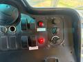 Control panel of a 2012 Ford Econoline featuring various switches knobs and warning lights including a red indicator light and labels for controls