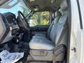 A 2011 Ford F-550 with a spacious cab featuring gray leather seats and a dashboard with various controls and connectors