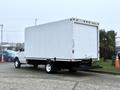 A 2019 Ford Econoline with a large white cargo box and rear liftgate parked on a lot