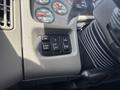 The image shows the dashboard controls of a 2013 International WorkStar including buttons for mirror adjustment lights and panel settings