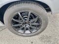 A close-up view of a black alloy wheel with a multi-spoke design and a tire labeled BFGoodrich mounted on a 1968 Ford Mustang convertible