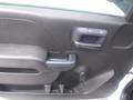 A close-up view of the interior door handle of a 2015 Chevrolet Silverado 1500 featuring a black plastic design and a simple ergonomic shape