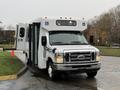 A white 2017 Ford E450 bus with a side entry ramp and wheelchair accessibility features