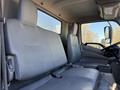 Interior view of a 2014 Hino 195 cab featuring two gray upholstered seats with seatbelts and a simple dashboard design
