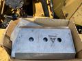 A boxed set of metal cutting teeth for a 2010 Vermeer Corporation BC1200XL wood chipper with three circular holes in each piece