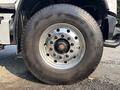 A close-up of a large steel wheel and tire from a 2016 Freightliner M2 106 showcasing the round wheel rim and thick rubber tire tread