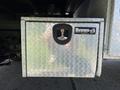 A metallic storage box with a diamond plate pattern and a keyhole labeled Buyers on a 2019 Ford F-550