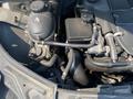 An engine compartment of a 2013 Mercedes-Benz C-Class with various components including hoses a reservoir and a black box
